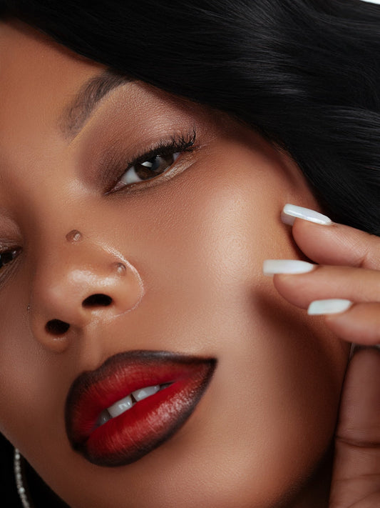 Close-up of a woman wearing magnetic lashes with flawless makeup and red lipstick