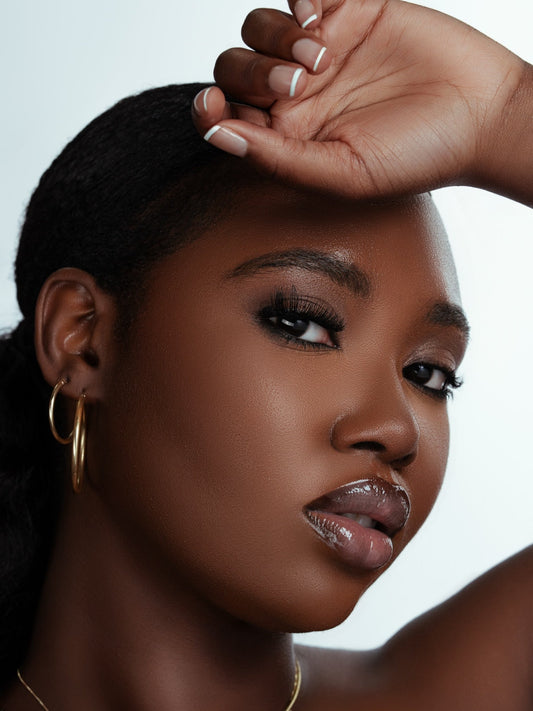 Close-up portrait of a woman wearing magnetic lashes with voluminous, natural-looking eyelashes and flawless makeup