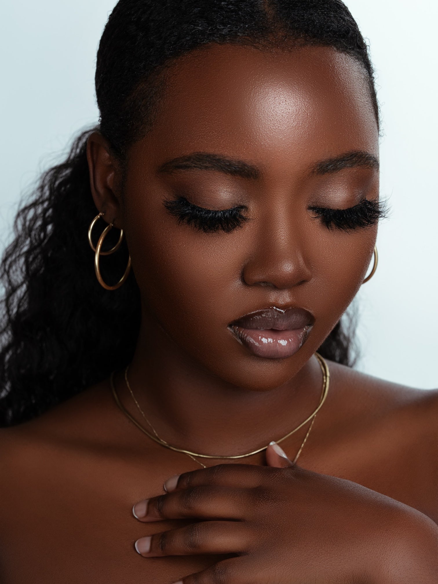 Woman with luxurious, thick mink lashes wearing Lucy Lash Box, showcasing glamorous eye makeup.
