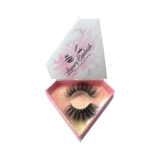 Hand-made false eyelash product made of 100% real mink fur with 25mm length and natural volume in a pink glittery diamond-shaped box.