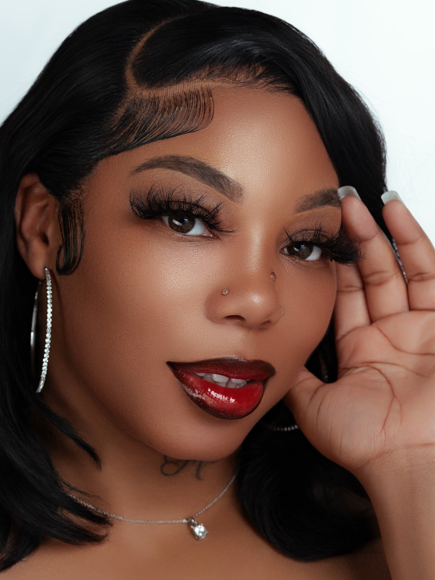 Close-up of a woman wearing luxurious, real mink lashes from the Lucy Lash Box with flawless makeup and glossy red lips