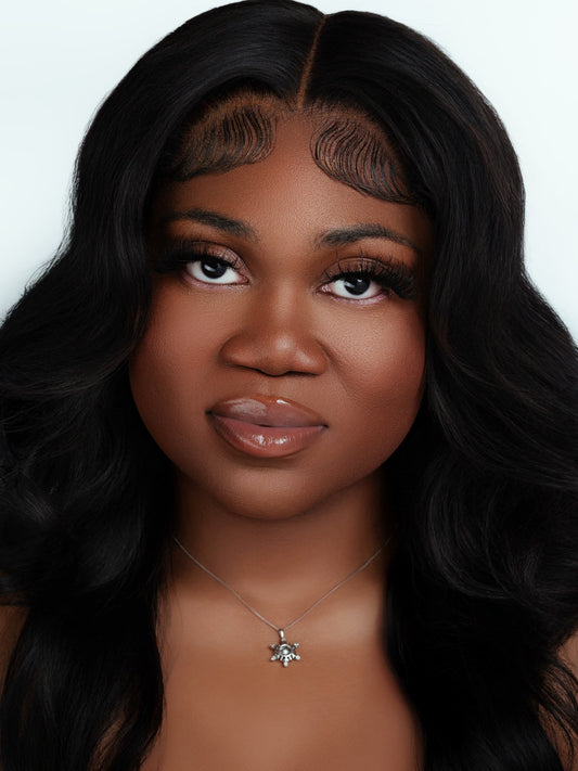 Close-up portrait of a woman with long, wavy black hair wearing realistic Velvet strip lashes that mimic eyelash extensions.