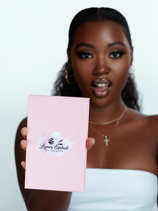 Woman holding pink Lucy Lash Box with luxury eyelash extension logo