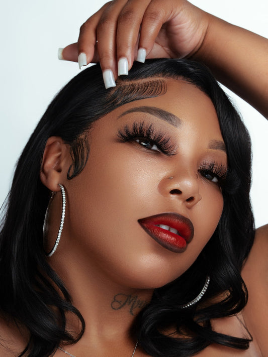Close-up of woman wearing soft, voluminous false eyelash product made from 100% real mink fur with natural sheen.
