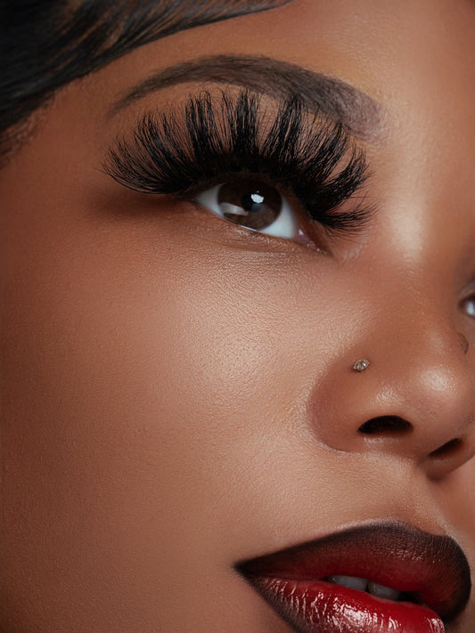 Close-up of a woman's eye wearing Foxy 70A real mink fur eyelashes, showcasing soft, hand-made lashes with 25mm length and natural volume.