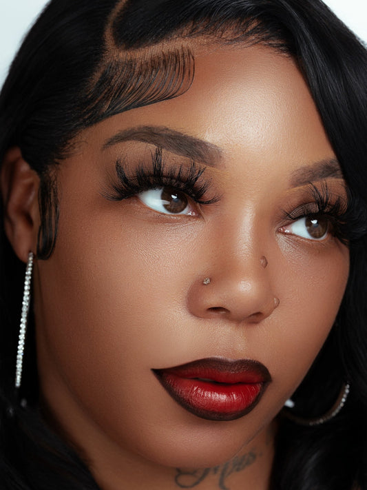 Close-up of a woman wearing Dior 100% real mink fur false eyelashes, 25mm length, hand-made for a natural voluminous look.