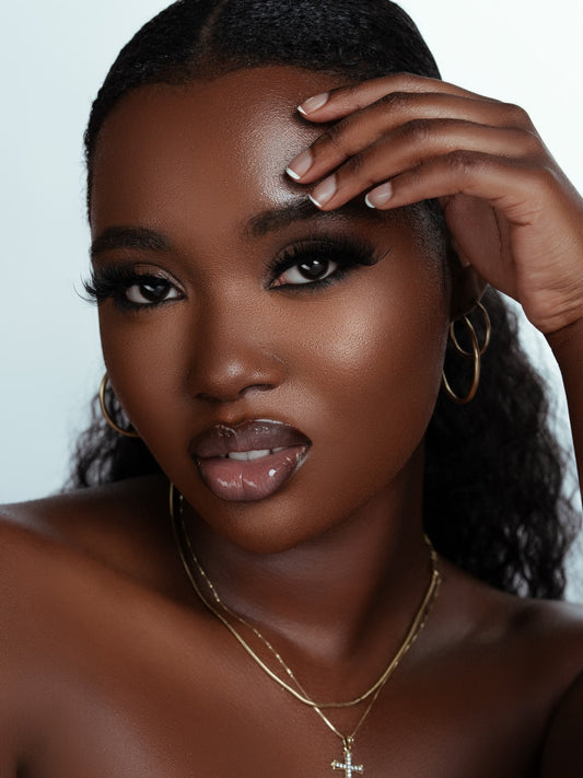 Close-up of woman wearing luxurious Tease strip lashes with dramatic volume and length, showcasing soft, fluffy texture and flawless makeup look.