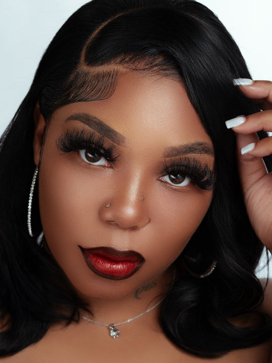 Close-up of a woman wearing Valentina strip lashes with bold makeup and styled hair