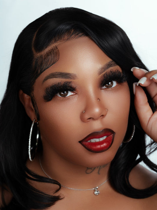 Close-up portrait of a woman with 2.5cm size voluminous mink fur eyelashes and glossy red lipstick