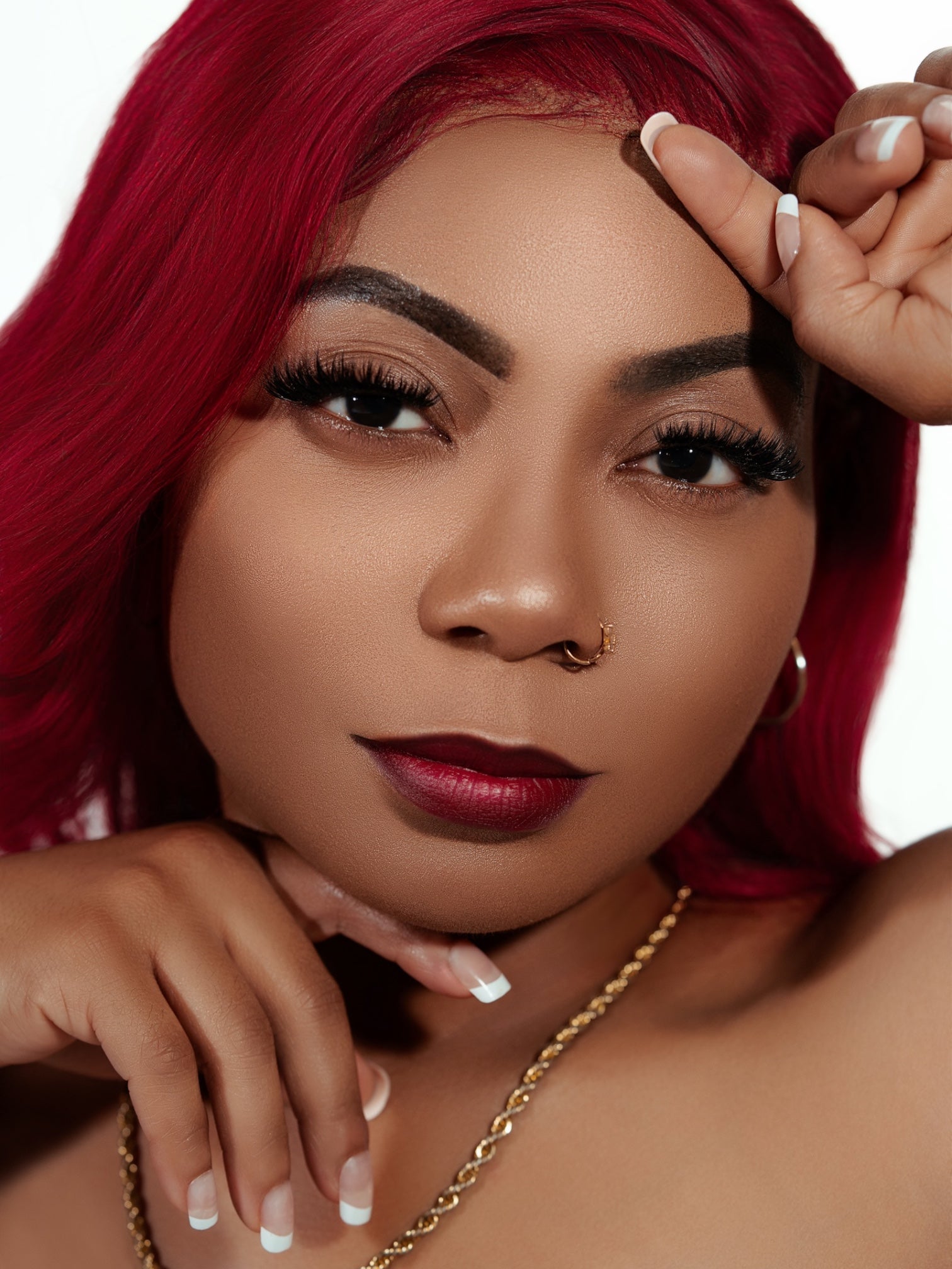 Close-up of woman with luxury mink cluster eyelash extensions, red hair, and bold makeup showcasing Clusters DY042 lashes.