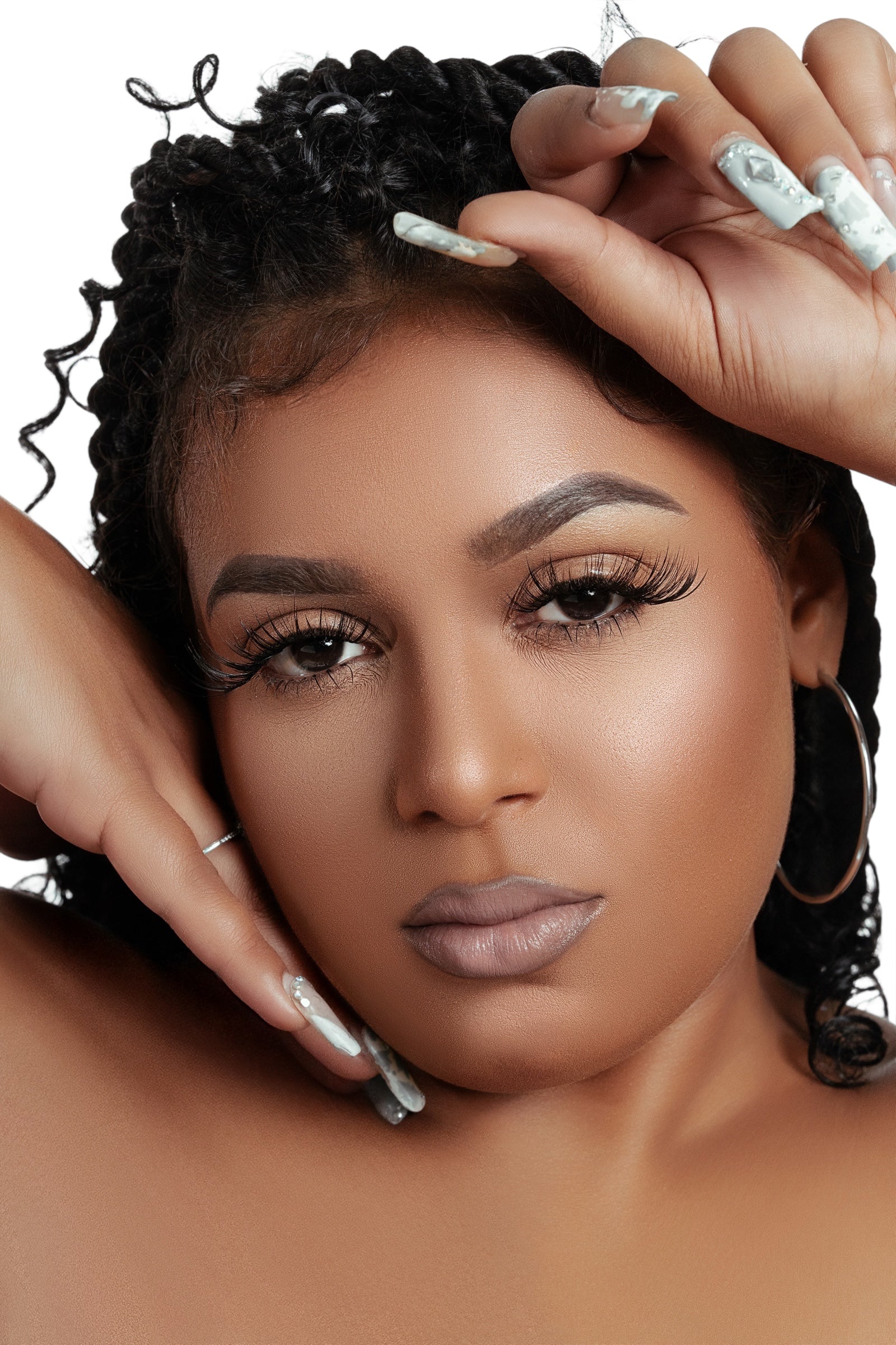 Close-up of a woman wearing luxurious natural-looking mink cluster eyelash extensions Clusters DY040 with long curled lashes and manicured nails
