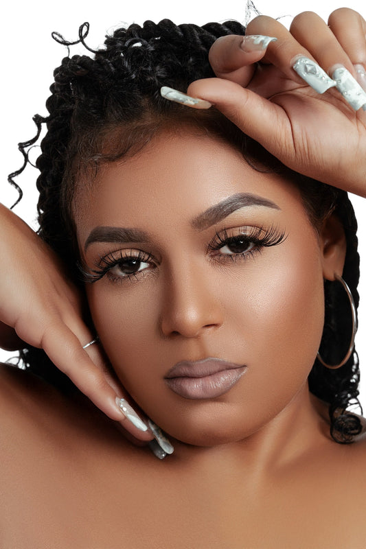 Close-up of a woman wearing luxurious natural-looking mink cluster eyelash extensions Clusters DY040 with long curled lashes and manicured nails